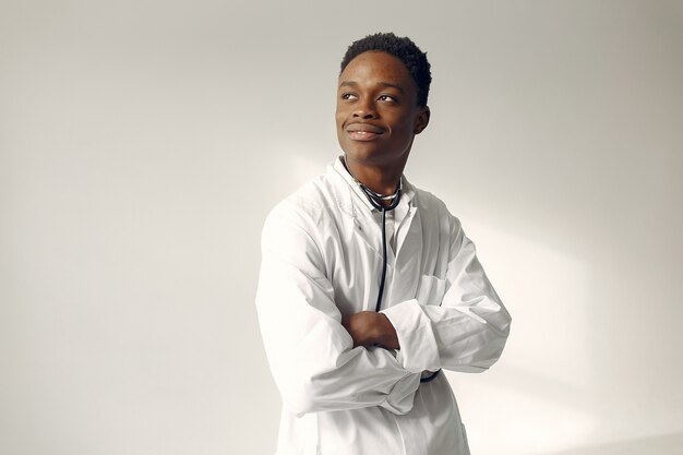 Black doctor in a white uniform with a stethoscope