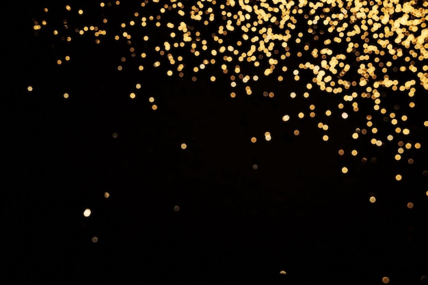 Черный праздничный фон абстрактная россыпь золотых блесток на черном праздничном фоне
