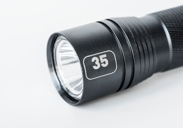 Black flashlight isolated on white background