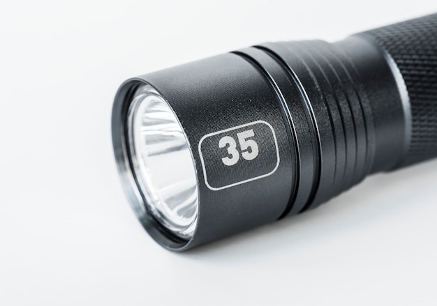 Black flashlight isolated on white background