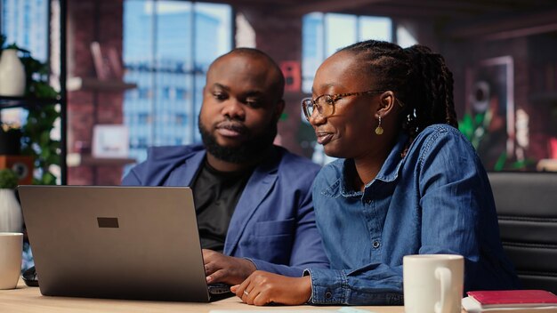 Black freelancers team at home desk using laptop and checking emails
