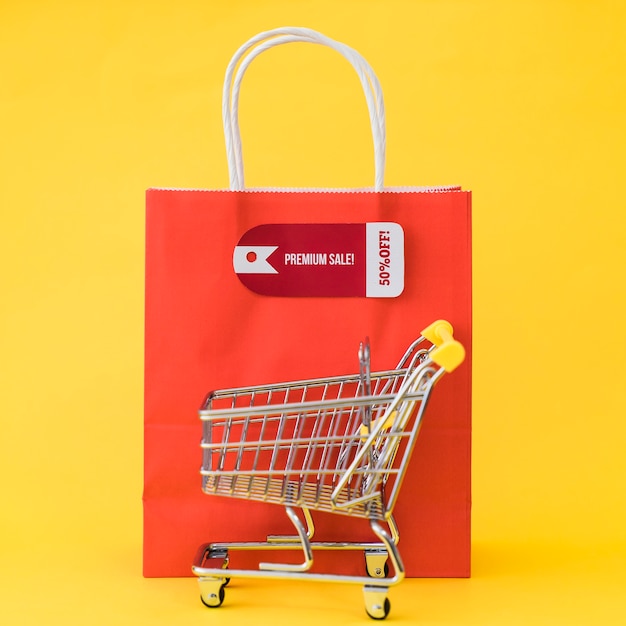 Black friday composition with cart in front of bag