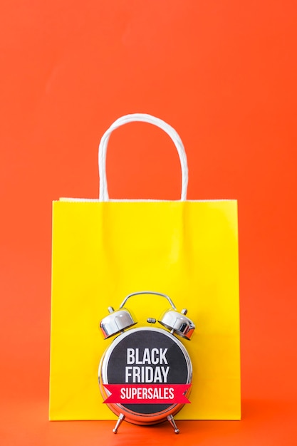 Black friday concept with bag and alarm
