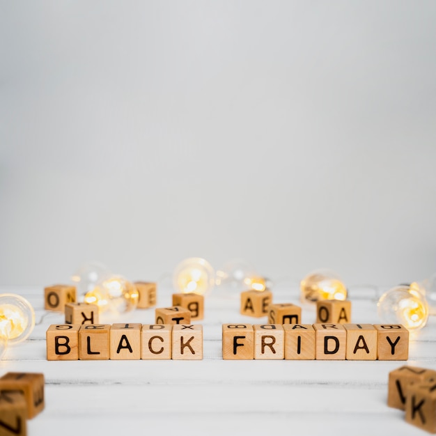 Free photo black friday cubes on wooden table with copy space