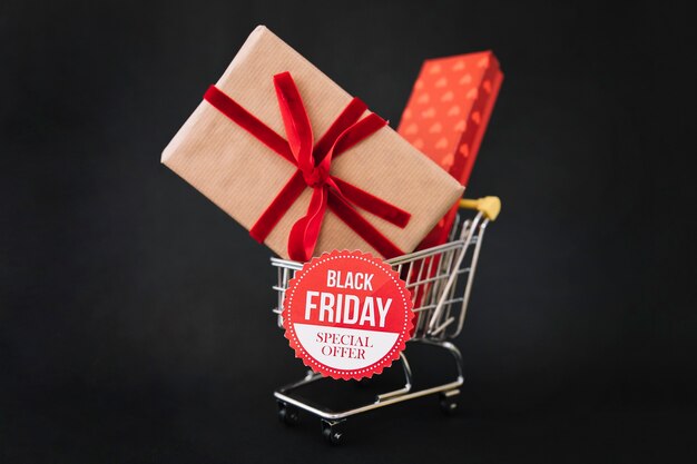 Black friday decoration with gift boxes in shopping cart
