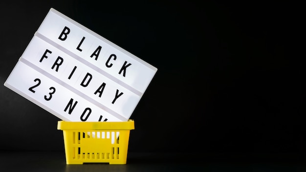 Free photo black friday inscription on board in shopping basket