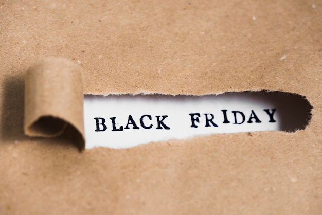 Free photo black friday inscription between craft paper