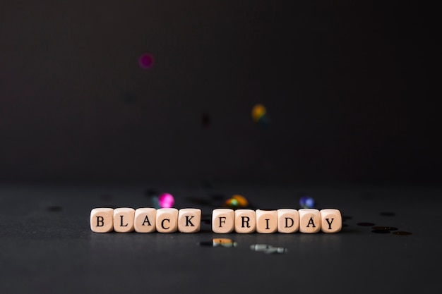 Black Friday inscription on cubes with confetti 