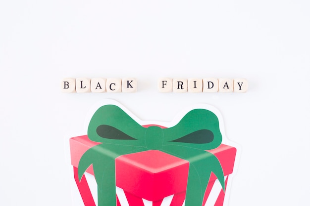 Black Friday inscription on cubes with paper gift box 