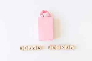 Free photo black friday inscription on cubes with shopping bag