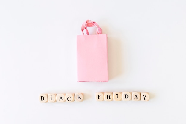 Black Friday inscription on cubes with shopping bag 