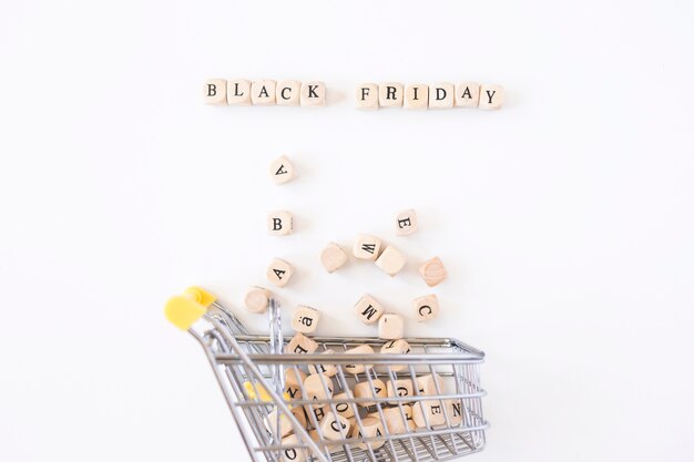 Black Friday inscription on cubes with small grocery cart