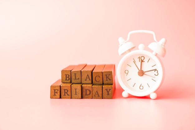 Black Friday inscription near alarm clock 