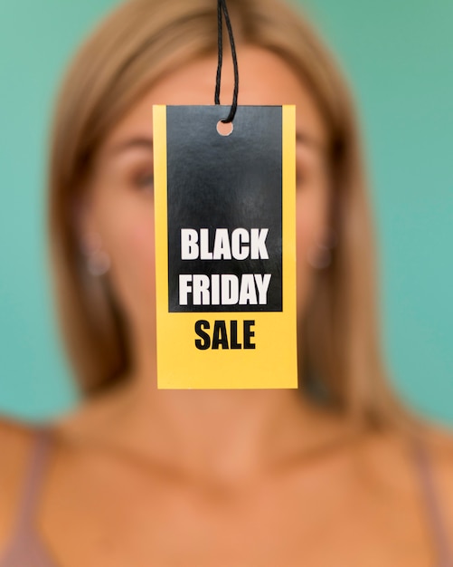 Free photo black friday sale label held by blurred woman