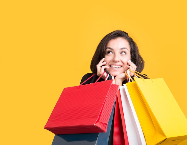 Black friday sale model being covered by shopping bags