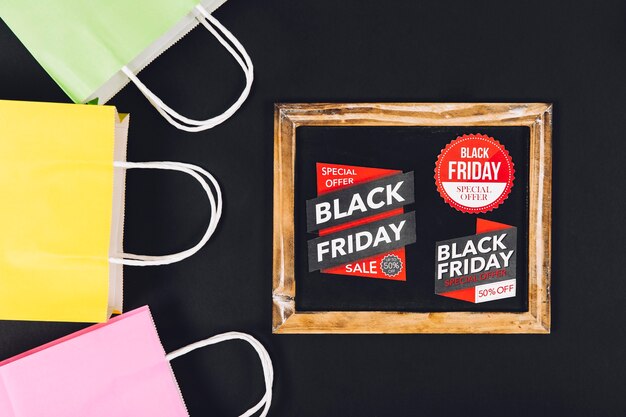 Black friday sales composition with slate and three bags