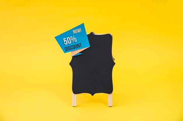 Black friday sales concept with board and origami label