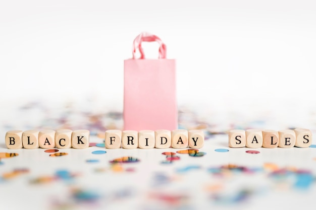 Black Friday sales inscription on cubes with shopping bag 