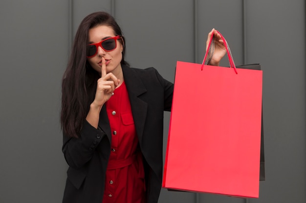 Black friday sales woman doing a silence gesture