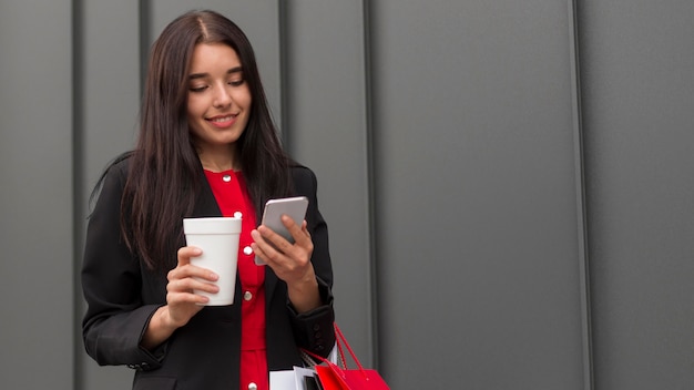 Black friday sales woman with coffee and mobile phone