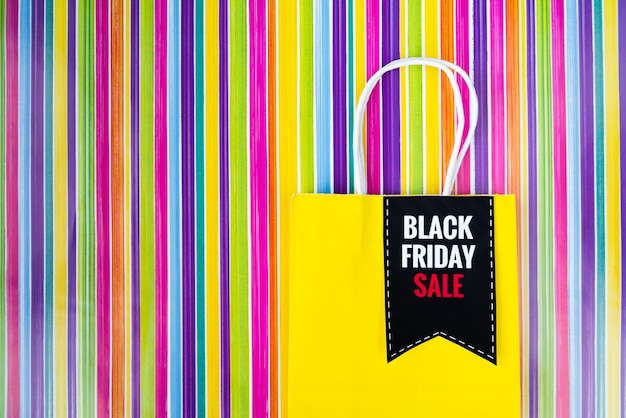 Black friday shopping bag on colorful background