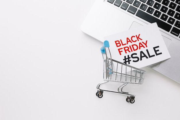 Black friday shopping cart and laptop with copy space