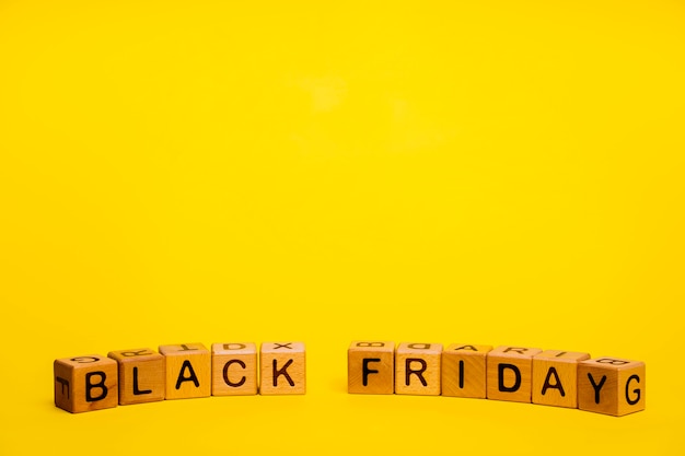Black friday word on yellow background with copy space