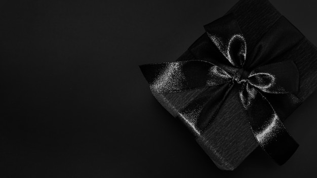Black gift on dark background