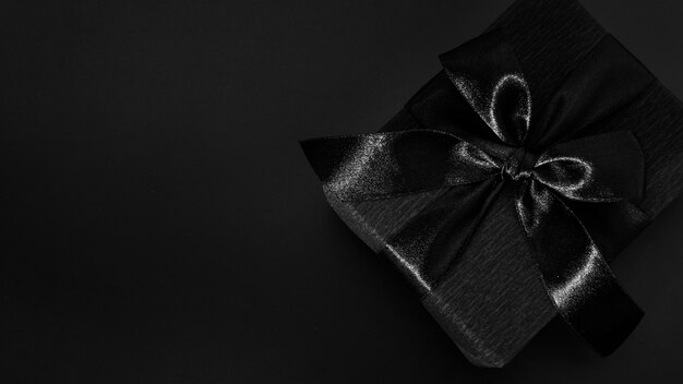 Black gift on dark background