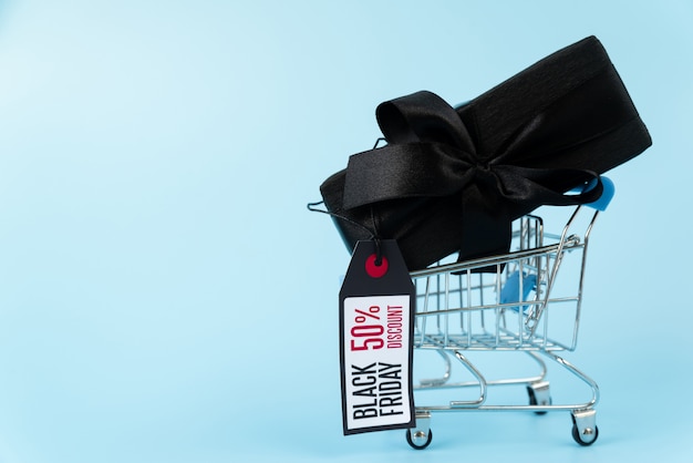 Black gift in shopping cart with tag