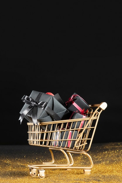 Free photo black gifts in golden shopping cart