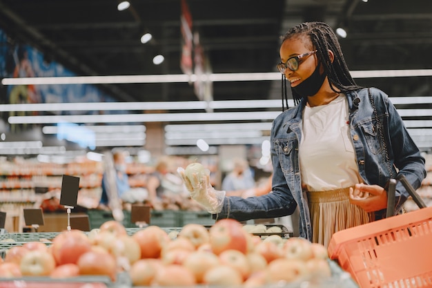 Free photo black girl in a mask buy a food