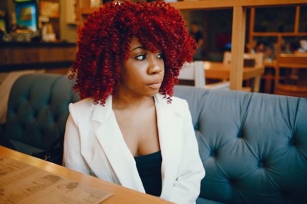 Black girl sitting in a cafe