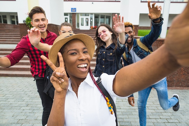 Free photo black girl taking selfie with classmates