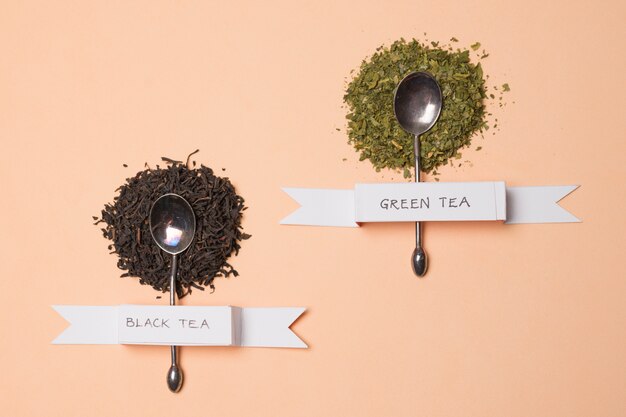 Black and green herbal tea label on herbs over the peach backdrop