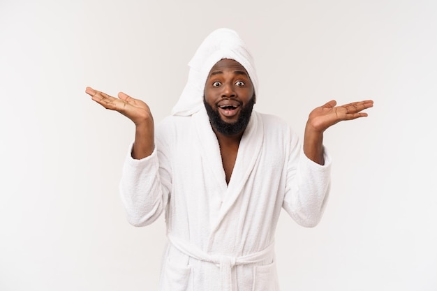 Free photo black guy wearing a bathrobe pointing finger with surprise and happy emotion isolated over whtie background