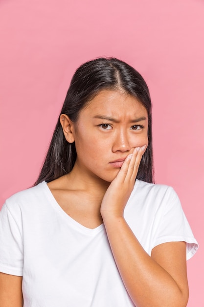 Black hair woman frowning and looking at camera 