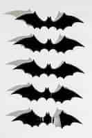 Free photo black halloween plastic bats in line