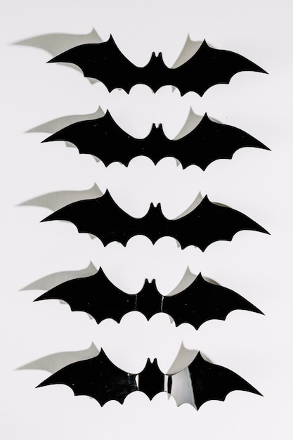 Free Photo black halloween plastic bats in line