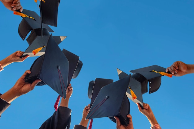 Black hat of the graduates floating in the sky.