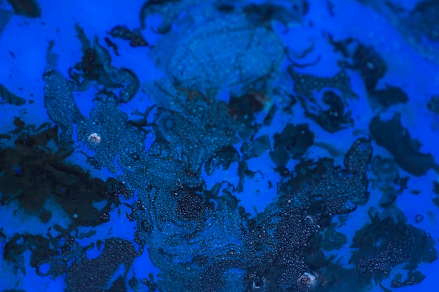 Black ink mixed in the blue paint color