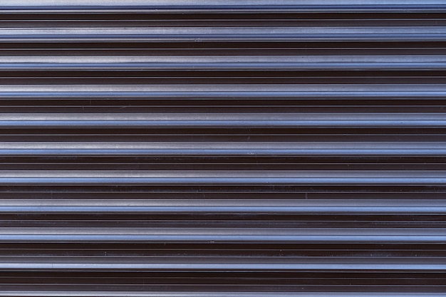 Free photo black iron tin fence lined background. metal texture