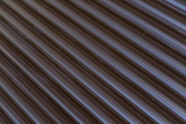 Black iron tin fence lined background. Metal texture