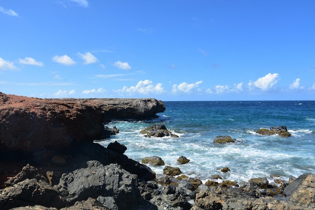 Black Lava Rock with Waves Coming Ashore in Aruba