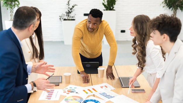 Black male team leader at business meeting in an office