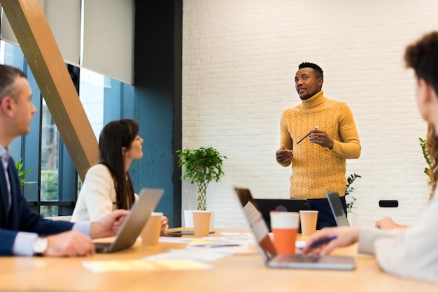 Free photo black male team leader at business meeting in an office