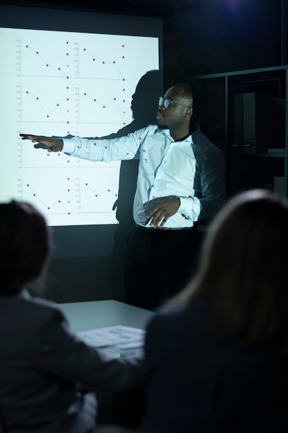 Black man giving presentation on a meeting
