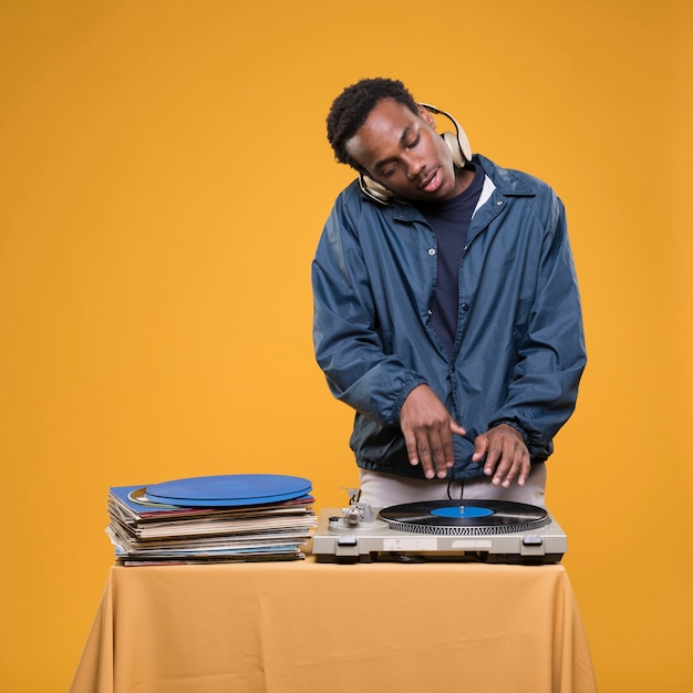 Black man posing with vinyls