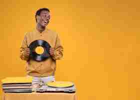 Free photo black man posing with vinyls