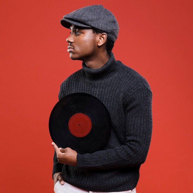 Black man posing with vinyls